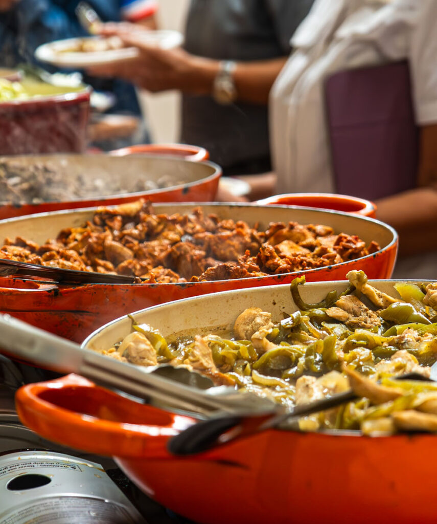 A Cazuelita's catering team member tending the buffet